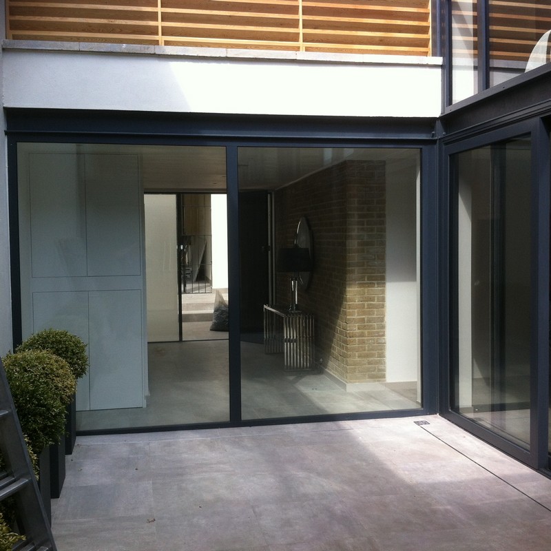 Floor-to-ceiling sliding doors opening to courtyard in Eltham